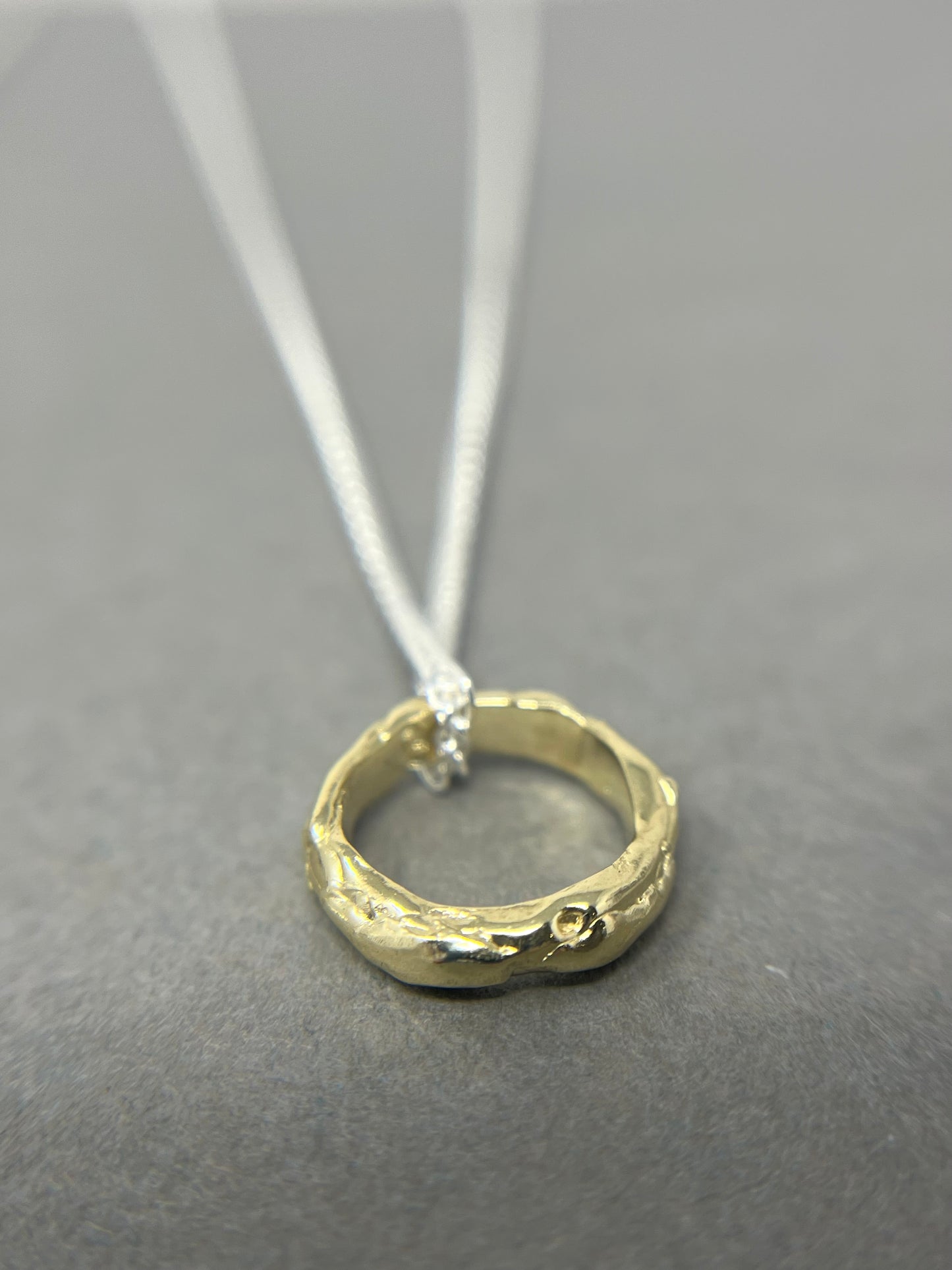 gold molten hoop necklace on silver chain